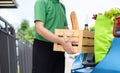 Food Delivery man giving fruit and vegetable shopping supermarket to receiver customer front house Royalty Free Stock Photo