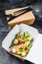 Food delivery paper box for breakfast with sandwich. Black background. Top view Royalty Free Stock Photo