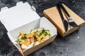 Food delivery paper box for breakfast with sandwich. Black background. Top view Royalty Free Stock Photo