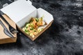 Food delivery paper box for breakfast with sandwich. Black background. Top view. Copy space Royalty Free Stock Photo