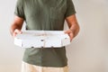 Food delivery service. A man holding a box of pizza on a white background. Close up Royalty Free Stock Photo