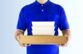 Food delivery service or order food online. Delivery man in blue Royalty Free Stock Photo