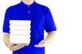 Food delivery service or order food online. Delivery man in blue uniform with hand holding paper packaging container fast food for Royalty Free Stock Photo
