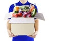 Food delivery service for order online grocery shopping concept. Delivery man in blue uniform hand holding paper box package. Royalty Free Stock Photo