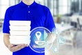 Food delivery service or order food online. Delivery man in blue uniform with hand holding fast food packaging container and icon Royalty Free Stock Photo