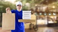 Food delivery service for order online shopping concept and icon media symbol. Delivery man in blue uniform hand holding paper bag Royalty Free Stock Photo