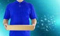 Food delivery service for order online shopping and icon media symbol. Delivery man in blue uniform hand holding paper box package Royalty Free Stock Photo