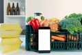 Food delivery service - smartphone in front of the box of groceries
