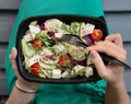 Woman eating healthy food at lunch time