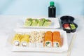 Food delivery takeaway concept. Lunch box with sushi set. Assorted sushi Philadelphia roll cheese with squid on white light Royalty Free Stock Photo