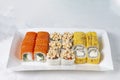 Food delivery takeaway concept. Lunch box with sushi set. Assorted sushi Philadelphia roll cheese with squid on white light Royalty Free Stock Photo