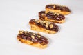 Food, desserts and bakery concept - Traditional French dessert eclairs with chocolate and nuts