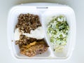 Food in disposable lunch box. Buckwheat, cream, cutlet and salad Royalty Free Stock Photo