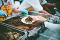 Food donation to help people in hunger relief : hands of the poor receive food from the donor`s share Royalty Free Stock Photo