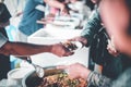 Food donation to help people in hunger relief : hands of the poor receive food from the donor`s share Royalty Free Stock Photo