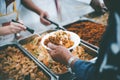 Food donation to help people in hunger relief : hands of the poor receive food from the donor`s share Royalty Free Stock Photo