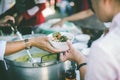 Food donation to help people in hunger relief : hands of the poor receive food from the donor`s share Royalty Free Stock Photo