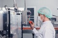 Food and drink factory engineer  staff worker operate machine at production line. beverage products industry Royalty Free Stock Photo