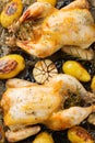 Food and drink, holidays eating dinner concept. Roasted chicken poussin with spices, herbs, garlic and small potatoes on a kitchen