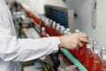 Food and drink industry staff worker working at conveyor belt production line machine in beverage factory with clean and hygiene Royalty Free Stock Photo