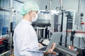 Food and drink industry staff worker working at conveyor belt production line machine in beverage factory with clean and hygiene Royalty Free Stock Photo