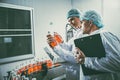 Food and drink industry staff worker working at conveyor belt production line machine in beverage factory with clean and hygiene Royalty Free Stock Photo