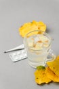 Food and drink, still life health care concept. Ginger tea infusion beverage in glass cup, yellow leaves, thermometer, pills on Royalty Free Stock Photo