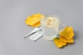 Food and drink, still life health care concept. Ginger tea infusion beverage in glass cup, yellow leaves, thermometer, pills on Royalty Free Stock Photo