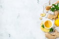 Food and drink, still life health care concept. Ginger tea infusion beverage in white cup with lemon mint honey on a kitchen table