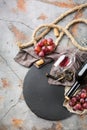 Bottle, corkscrew, glass of red wine, grapes on a table Royalty Free Stock Photo