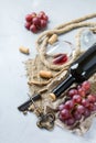 Bottle, corkscrew, glass of red wine, grapes on a table Royalty Free Stock Photo