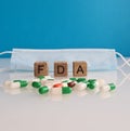 Food and Drug Administration. Medical protective mask and pills FDA drug approval concept Royalty Free Stock Photo