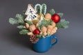 Christmas edible bouquet with nuts, sweets, nobilis and christmas decor in a blue cup