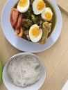 food in the form of white noodles, chicken meat, and eggs