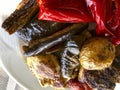 Food. Fragment a white plate with meat and slices of vegetables on a table in an outdoor cafe. Royalty Free Stock Photo