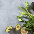 Food frame of green vegetables, avocado, cucumber, spinach, lime, celery on a gray concrete background. Flat lay Royalty Free Stock Photo