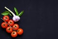 Food frame. Pasta ingredients. Cherry-tomatoes, spaghetti pasta, garlic, basil, parmesan and spices on dark background, copy Royalty Free Stock Photo