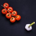 Food frame. Pasta ingredients. Cherry-tomatoes, spaghetti pasta, garlic, basil, parmesan and spices on dark background, copy Royalty Free Stock Photo