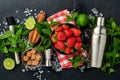 Food fresh ingredients for making lemonade, infused detox water or cocktail. Strawberries, lime, mint, basil, cane sugar, ice Royalty Free Stock Photo