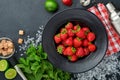 Food fresh ingredients for making lemonade, infused detox water or cocktail. Strawberries, lime, mint, basil, cane sugar,  ice cub Royalty Free Stock Photo