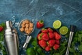 Food fresh ingredients for making lemonade, infused detox water or cocktail. Strawberries, lime, mint, basil, cane sugar, ice Royalty Free Stock Photo