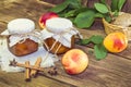 Food, harvest, canned fruit. Spicy peach jam homemade jam in a glass jar of fresh ripe fruits cinnamon on a wooden background in a Royalty Free Stock Photo