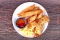 Deep fried spring roll,and frence fries sreved with tomato souce and chili sauce.