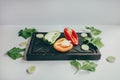 Food, healthy eating and nutrition concept - sliced pumpkin and other vegetables on wooden board. Fresh vegetables and greens on a