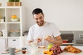 Man eating toast with coffee at home kitchen Royalty Free Stock Photo