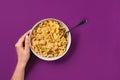 Food, healthy eating, people and diet concept - close up of woman eating muesli for breakfast over purple background Royalty Free Stock Photo