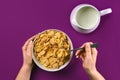 Food, healthy eating, people and diet concept - close up of woman eating muesli with milk for breakfast over purple Royalty Free Stock Photo