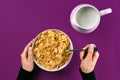 Food, healthy eating, people and diet concept - close up of woman eating muesli with milk for breakfast over purple Royalty Free Stock Photo