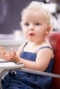 Food, high chair and baby eating, healthy diet and nutrition for breakfast in the morning at home. Hungry, kid and Royalty Free Stock Photo