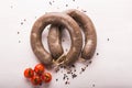 Food, horse meat and delicious concept - sliced sausage with tomato and pepper Royalty Free Stock Photo